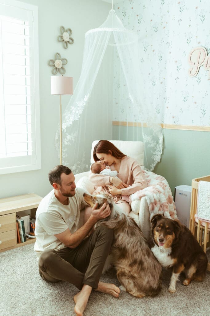 Arizona newborn photographer documenting newborn baby girl wrapped in pink swaddle during natural lifestyle newborn session in Scottsdale area