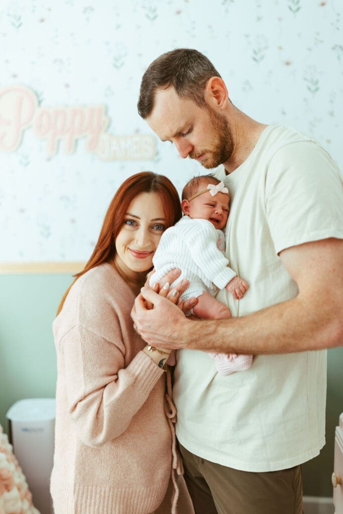 Paradise Valley newborn family photography featuring newborn baby girl in mother’s arms beside family dogs
