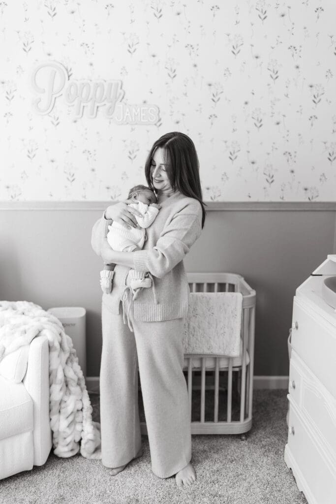 In-home lifestyle newborn photography session with newborn baby girl wrapped in blush swaddle in Scottsdale Arizona