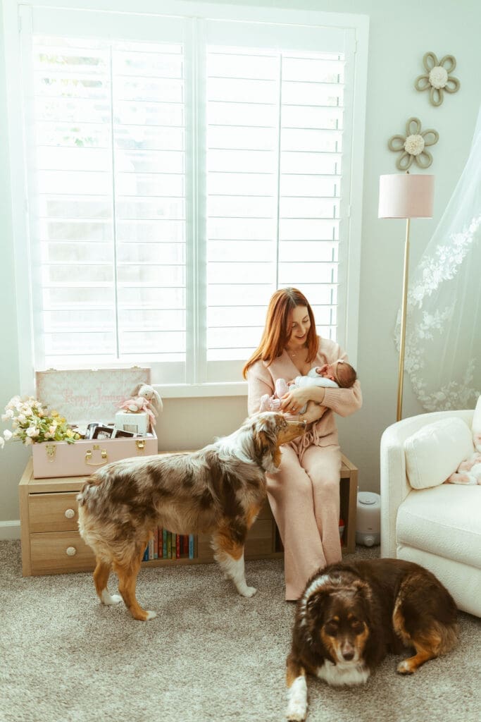 Scottsdale lifestyle newborn photographer capturing newborn baby girl in floral nursery with neutral and blush decor