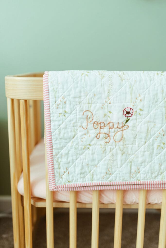 Paradise Valley Arizona lifestyle newborn photographer capturing baby girl sleeping in elegant floral nursery with soft blush decor