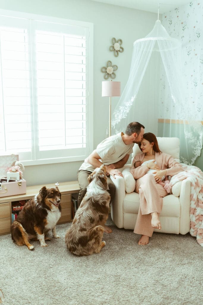 Scottsdale lifestyle newborn photographer capturing newborn baby girl wrapped in pink swaddle with cozy nursery details