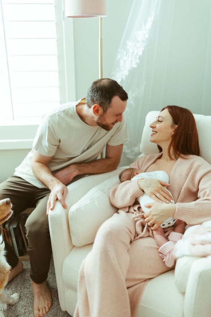 Paradise Valley family newborn photography featuring candid moments with parents, newborn baby, and Australian Shepherd dogs