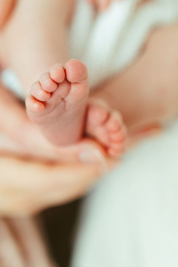 Natural in-home newborn session in Scottsdale Arizona with soft neutral styling and emotional newborn family portraits