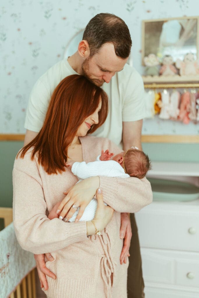 Scottsdale newborn photography featuring relaxed family cuddles on nursery floor during in-home lifestyle newborn session