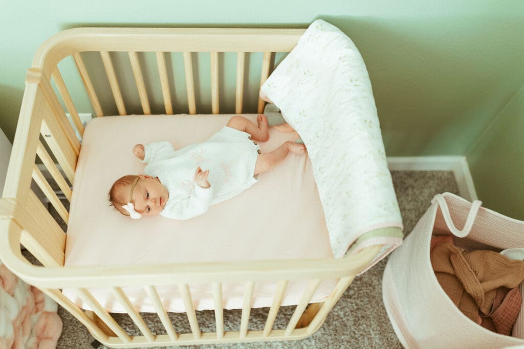 Newborn baby girl photographed in blush nursery during natural in-home newborn session near Scottsdale and Phoenix Arizona