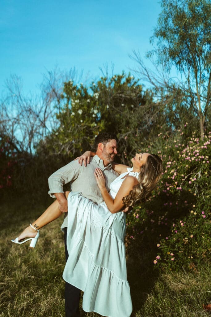 Mesa Arizona engagement photographer capturing elegant couple portraits with soft sunset light and greenery at The Meadow