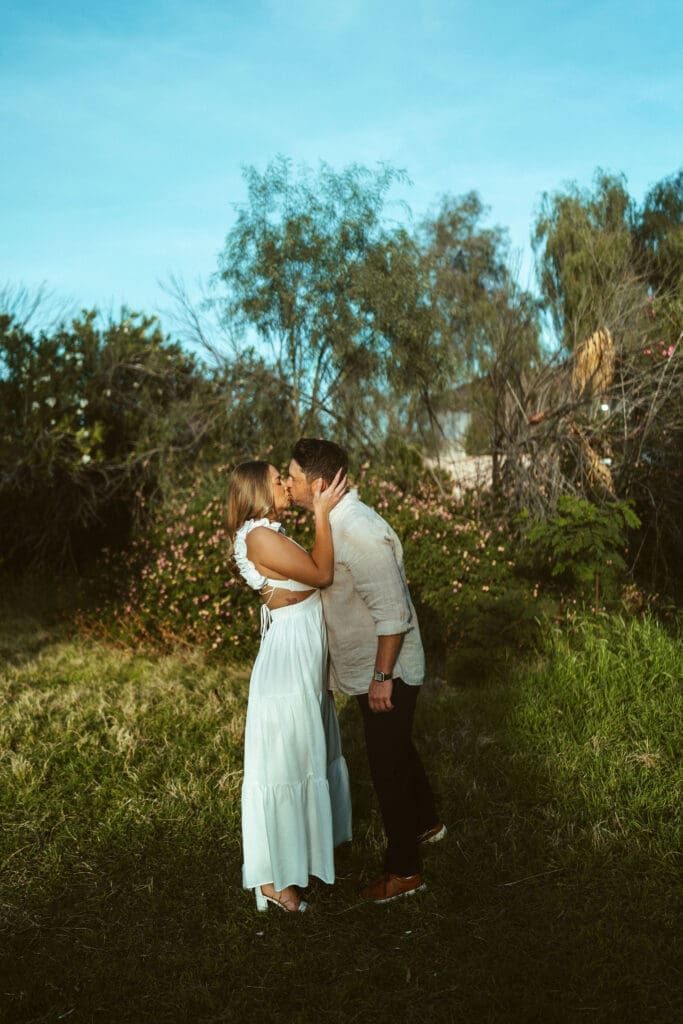 Mesa Arizona engagement photographer capturing natural connection and authentic couple interaction in outdoor field location