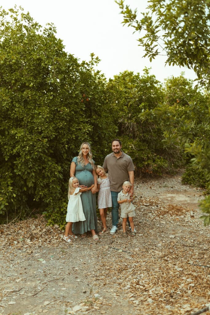 Family of five photographed during maternity session at Hagen Farms in Queen Creek Arizona