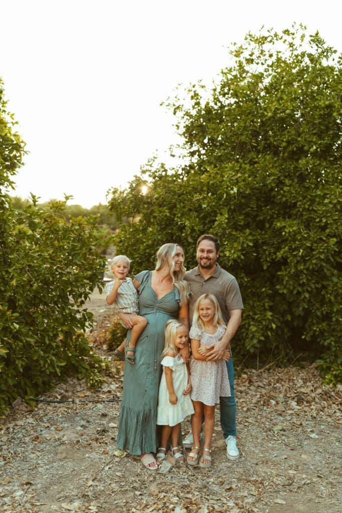 Arizona maternity photographer capturing family of five celebrating pregnancy at Hagen Farms in Queen Creek