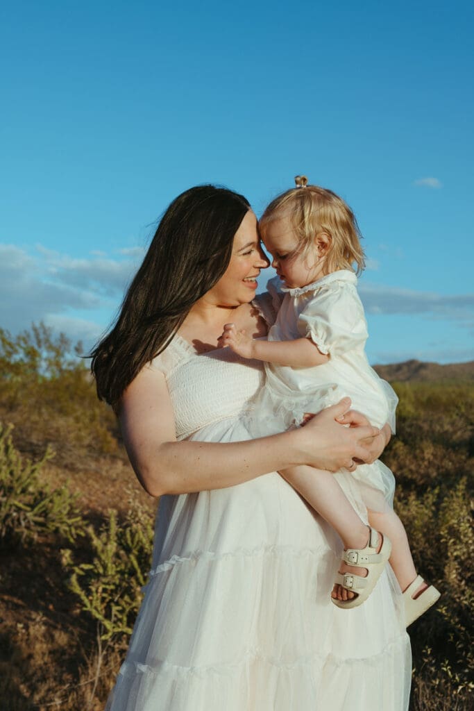 Arizona maternity photographer capturing joyful family expecting second baby during outdoor maternity session near Phoenix