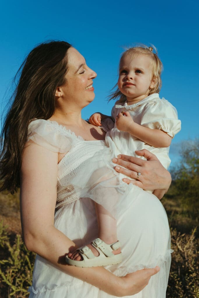 Scottsdale and Mesa maternity photographer documenting family awaiting newborn baby during golden hour desert photoshoot