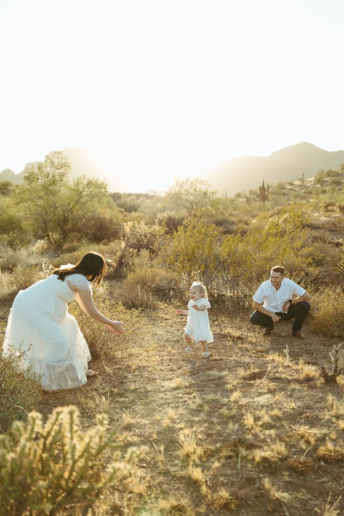 Mesa maternity photographer capturing toddler exploring Sonoran Desert during golden hour family maternity session at Phon D Sutton Recreation Area