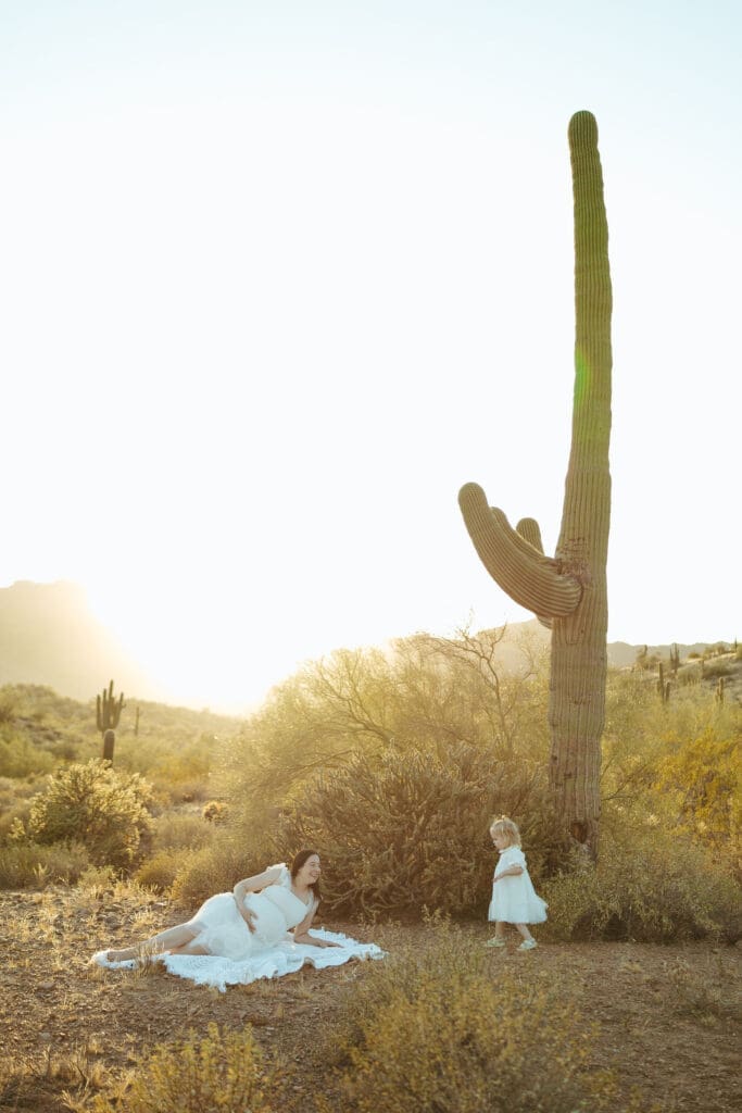 Gilbert maternity photographer documenting family maternity session with toddler and baby bump in Arizona desert landscape