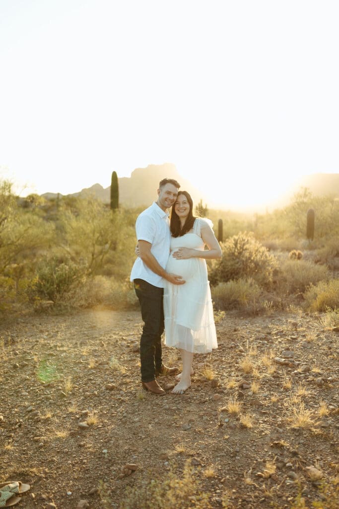 Paradise Valley maternity photographer capturing romantic maternity portraits of expecting parents during golden hour desert photoshoot