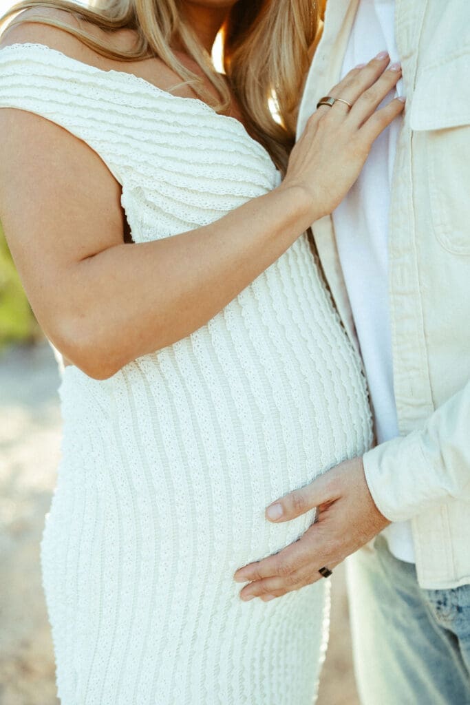 Salt River maternity photo session at Phon D Sutton Recreation Area in Mesa Arizona with glowing sunset light and romantic neutral outfits.