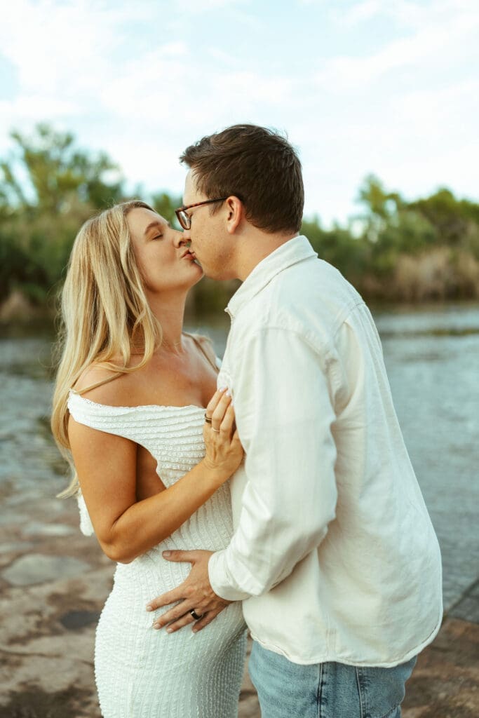 Close-up maternity portrait of pregnant couple embracing during a golden hour session at Phon D Sutton Recreation Area.