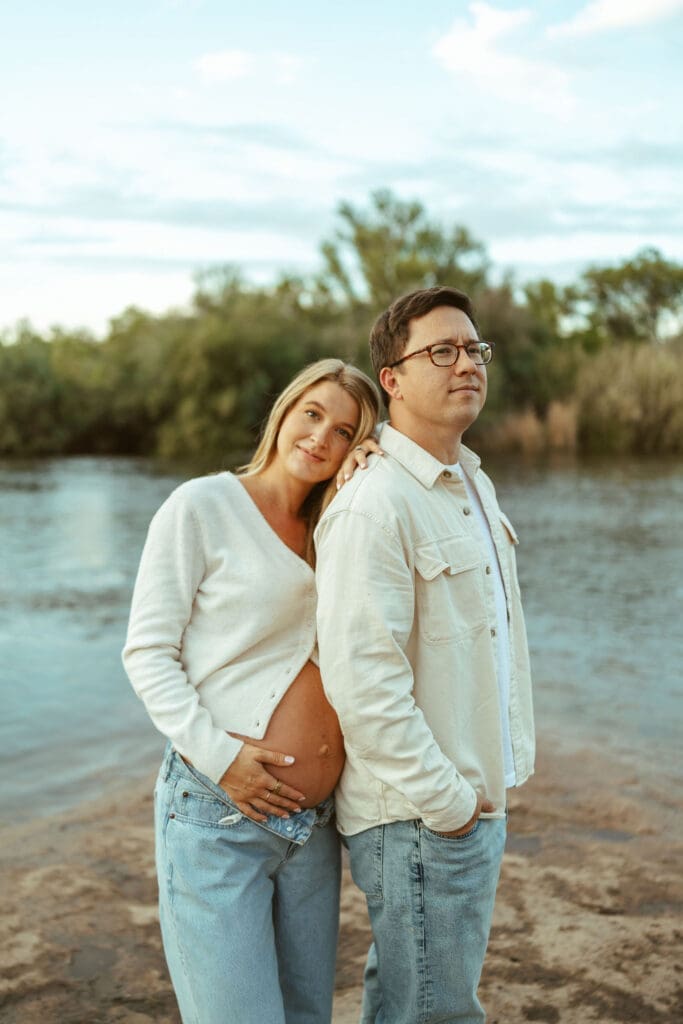 Pregnant woman leaning against her partner during an outdoor maternity session at Phon D Sutton Recreation Area.