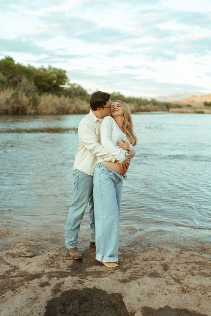 Pregnant mother walking through the Salt River during an artistic maternity session in Arizona.