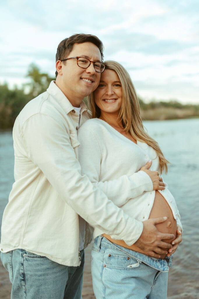 Close-up maternity portrait with soft natural posing and glowing sunset light near the Salt River.