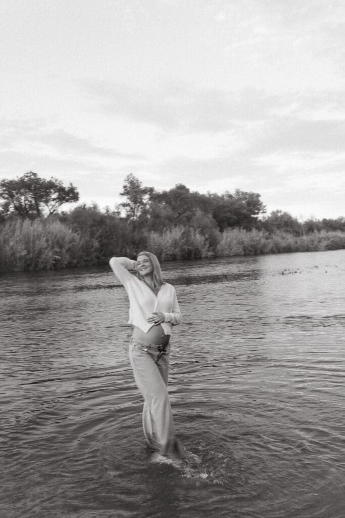 Moody maternity portrait featuring barefoot walking through the river at Phon D Sutton Recreation Area.