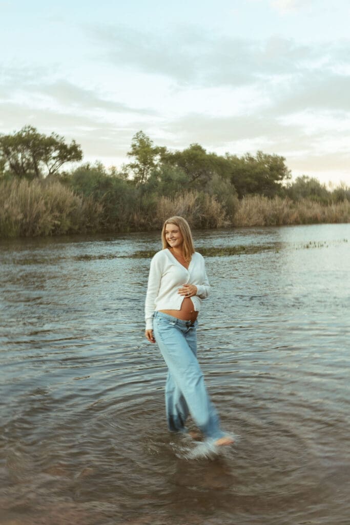 Expecting mother posing in the Salt River during golden hour maternity photos in Mesa Arizona.