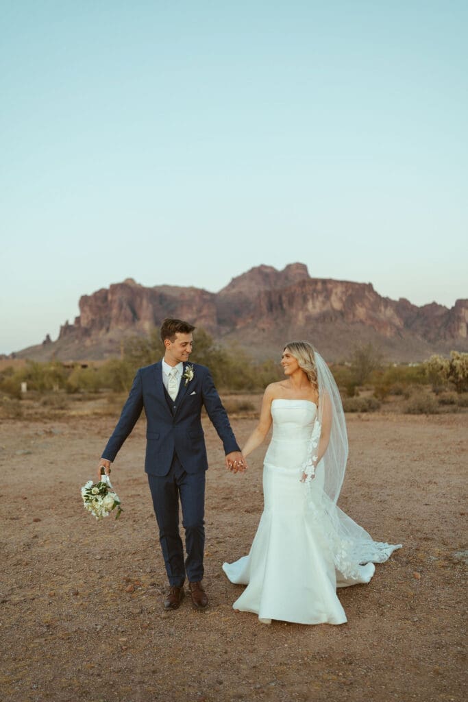 Arizona wedding couple posing beside saguaro cacti at The Paseo