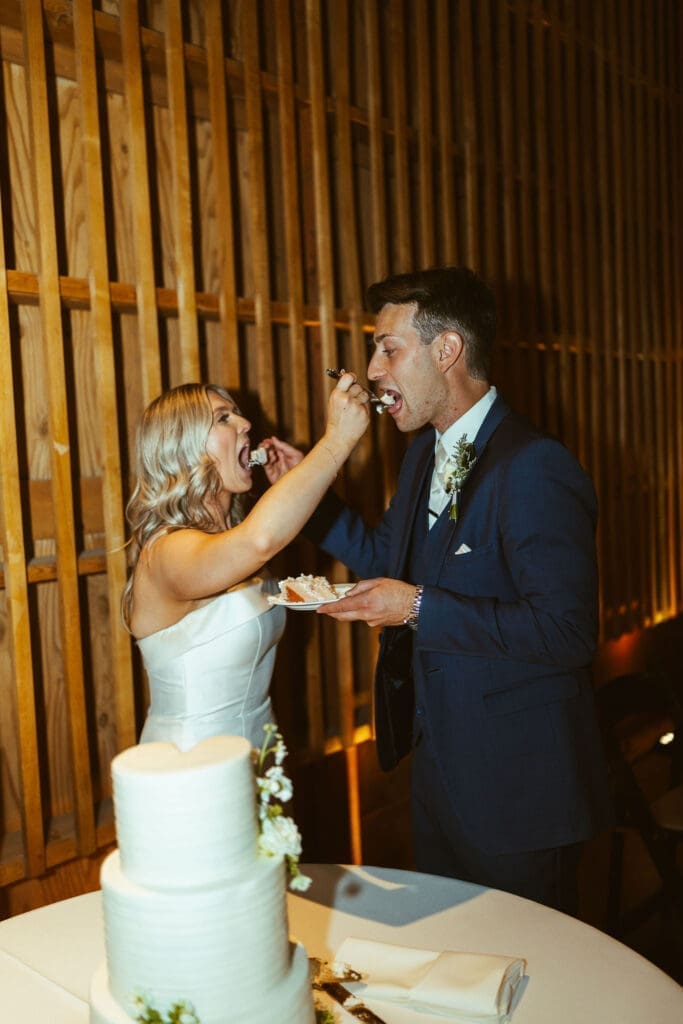 Elegant wedding reception at The Paseo Arizona with warm wood interiors and candlelight, cake cutting