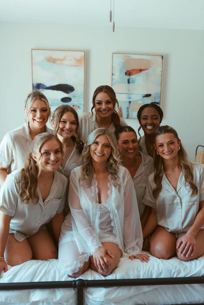 Bride and bridesmaids sharing emotional wedding morning moments in bridal suite