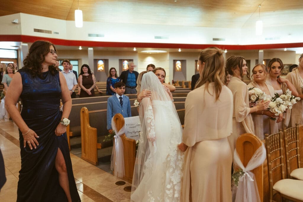 Bride and groom exchanging rings during Catholic wedding ceremony in Scottsdale