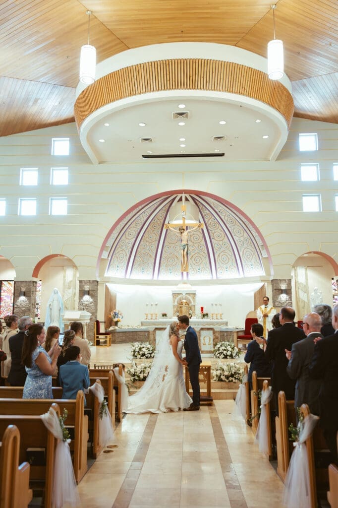 Bride and groom holding hands during Catholic church wedding in Scottsdale Arizona