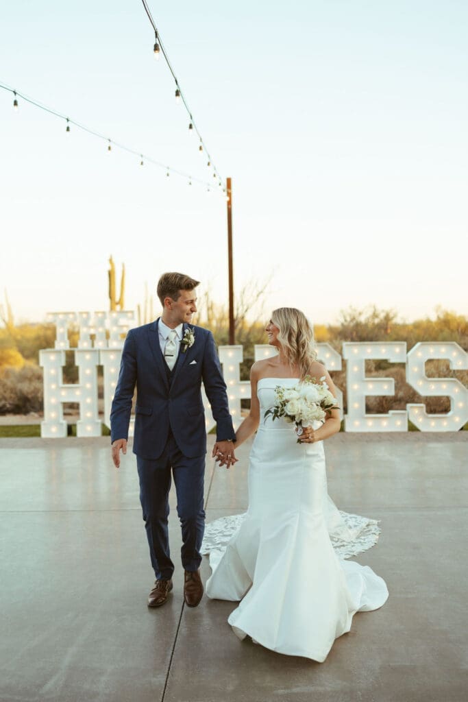 Bride and groom walking together during golden hour at The Paseo Arizona