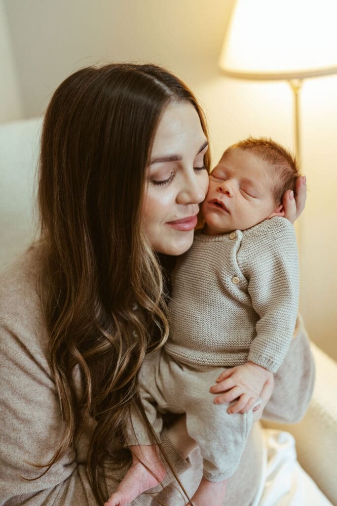 Phoenix area lifestyle newborn photographer documenting relaxed in-home newborn session with parents and newborn baby in Scottsdale Arizona, mom holding baby