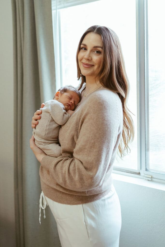 Scottsdale lifestyle newborn session with natural baby-led posing and soft neutral tones photographed by Arizona newborn photographer serving Scottsdale and Gilbert, mom holding newborn
