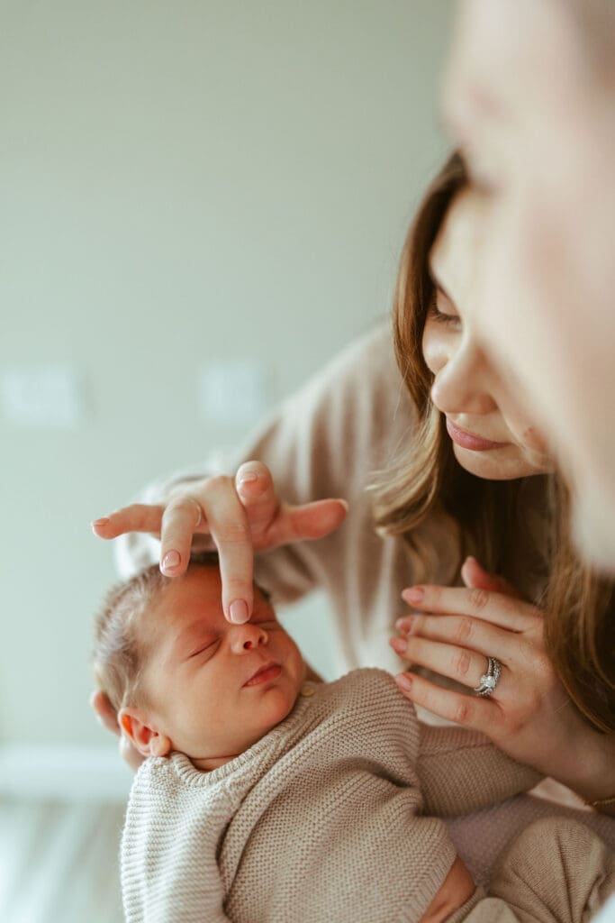 Scottsdale newborn photographer documenting soft candid newborn moments between parents and baby in luxury Arizona home near Gilbert and Chandler