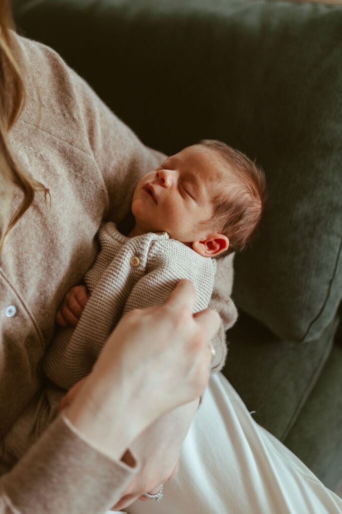 Scottsdale Arizona family newborn photography featuring mom gently soothing sleepy newborn during in-home lifestyle newborn session