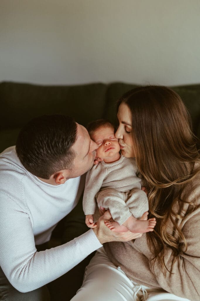 Scottsdale newborn family photography session featuring cozy couch cuddles and natural newborn moments inside Arizona family home