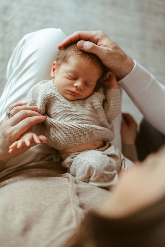 Scottsdale newborn photographer documenting natural newborn family moments with soft earthy tones and baby-led posing in Phoenix metro area