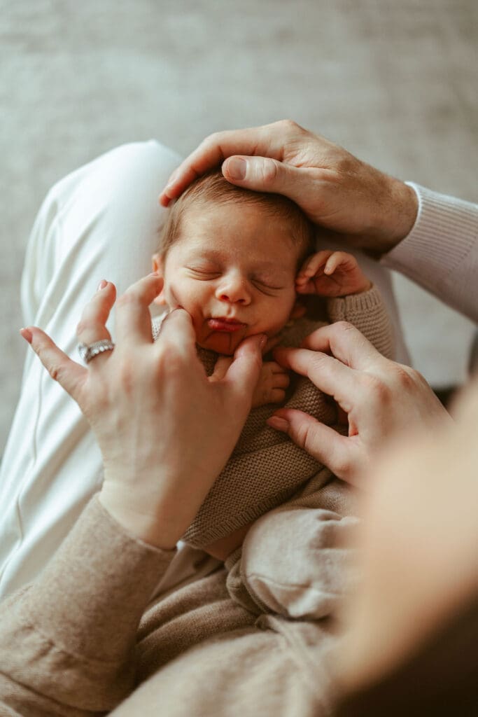 Scottsdale newborn photographer documenting natural newborn family moments with soft earthy tones and baby-led posing in Phoenix metro area