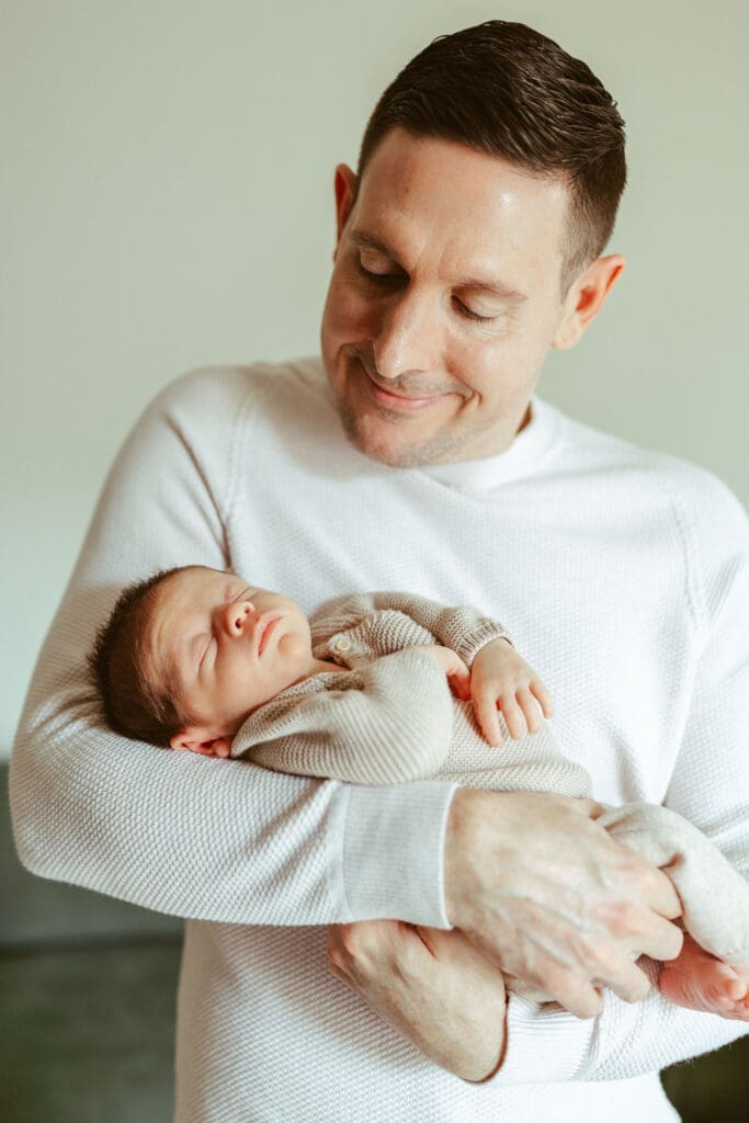 Scottsdale Arizona lifestyle newborn photography featuring newborn baby sleeping peacefully in neutral cream outfit during in-home newborn session