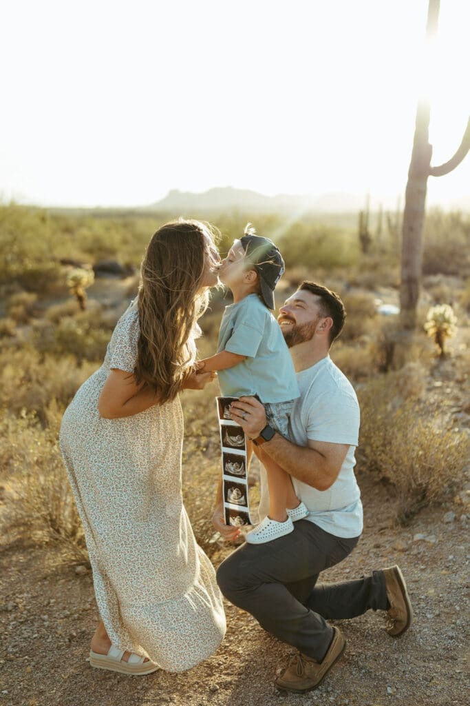 Arizona desert maternity photos with parents and toddler celebrating new baby announcement