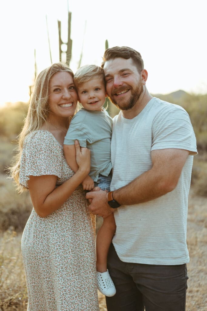 Mesa Arizona family photo session with parents and toddler posing in the Arizona desert landscape