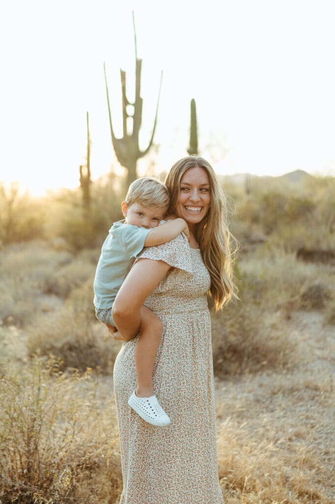 Lifestyle family photography session in Apache Junction Arizona featuring warm sunset light and cactus scenery