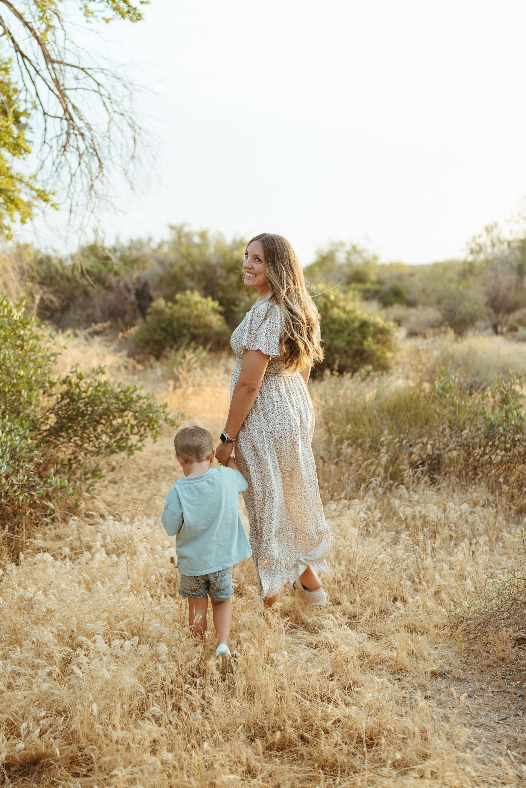 Arizona desert motherhood session with young family near the Superstition Mountains at sunset