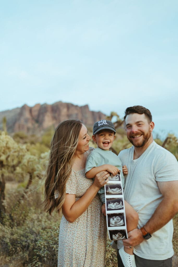 Family maternity photos in the Arizona desert featuring warm neutral tones and sunset scenery