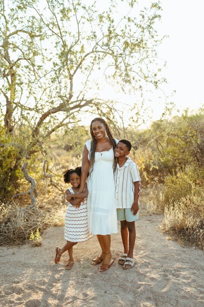 Mother and two children smiling together during an outdoor family photography session in Apache Junction