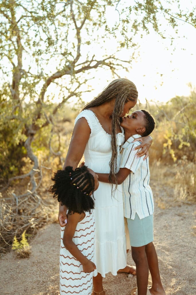 Mother embracing her children during a natural Scottsdale family photography session