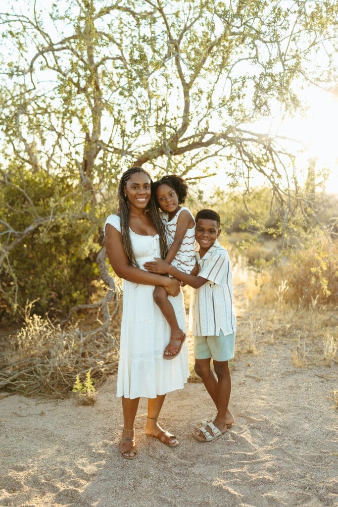 Arizona family portrait with mother and children standing together in the desert at golden hour