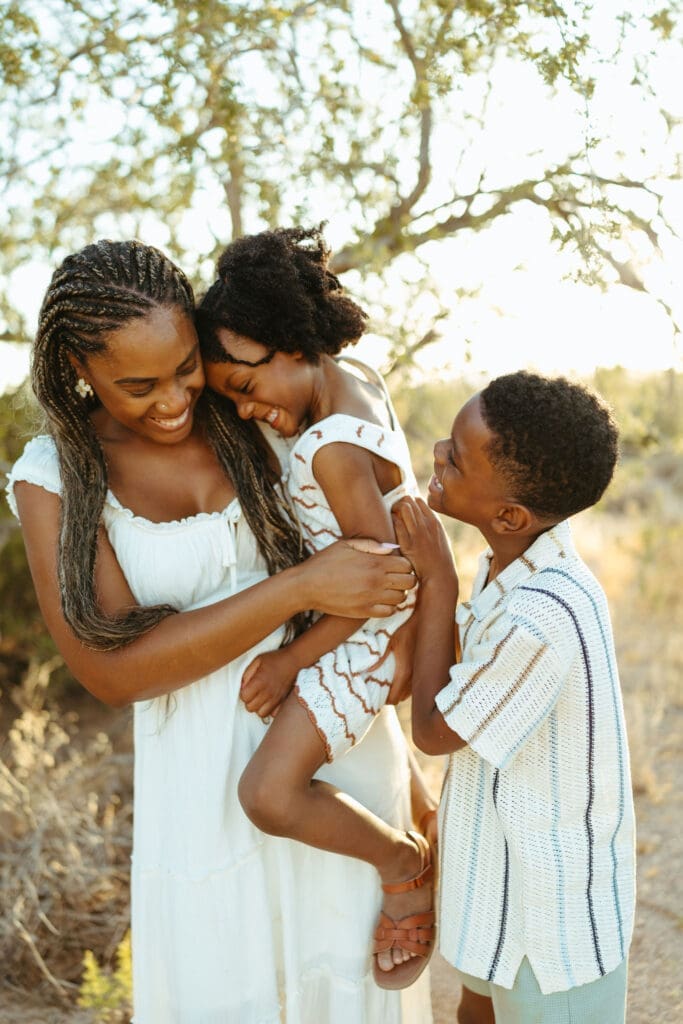 Mother laughing with her son and daughter during a family photography session near the Superstition Mountains in Arizona