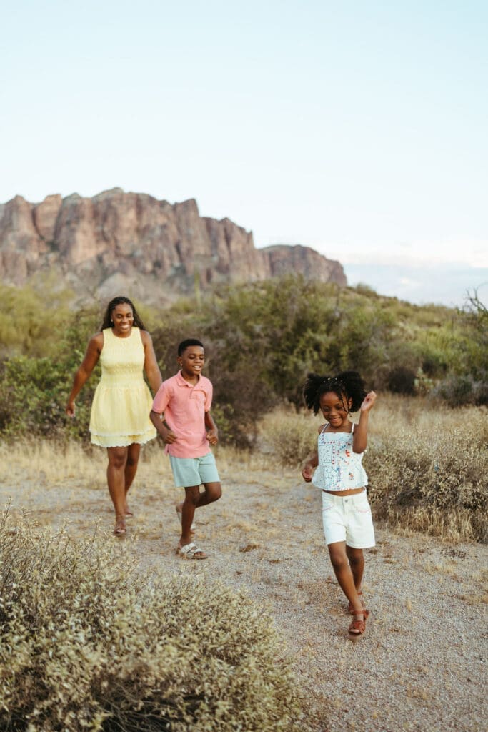 Family walking through the Arizona desert during a candid golden hour photography session